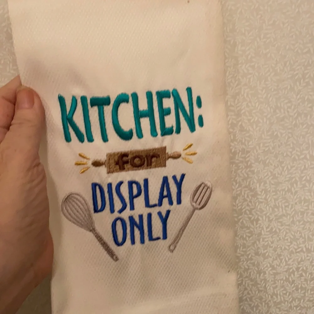 Embroidered kitchen towel “for display only”
