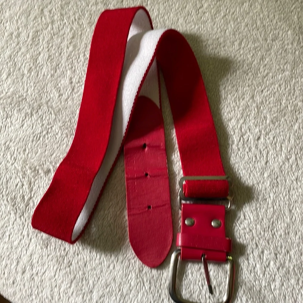 Red adjustable baseball belt. Fits 32” waist and smaller.