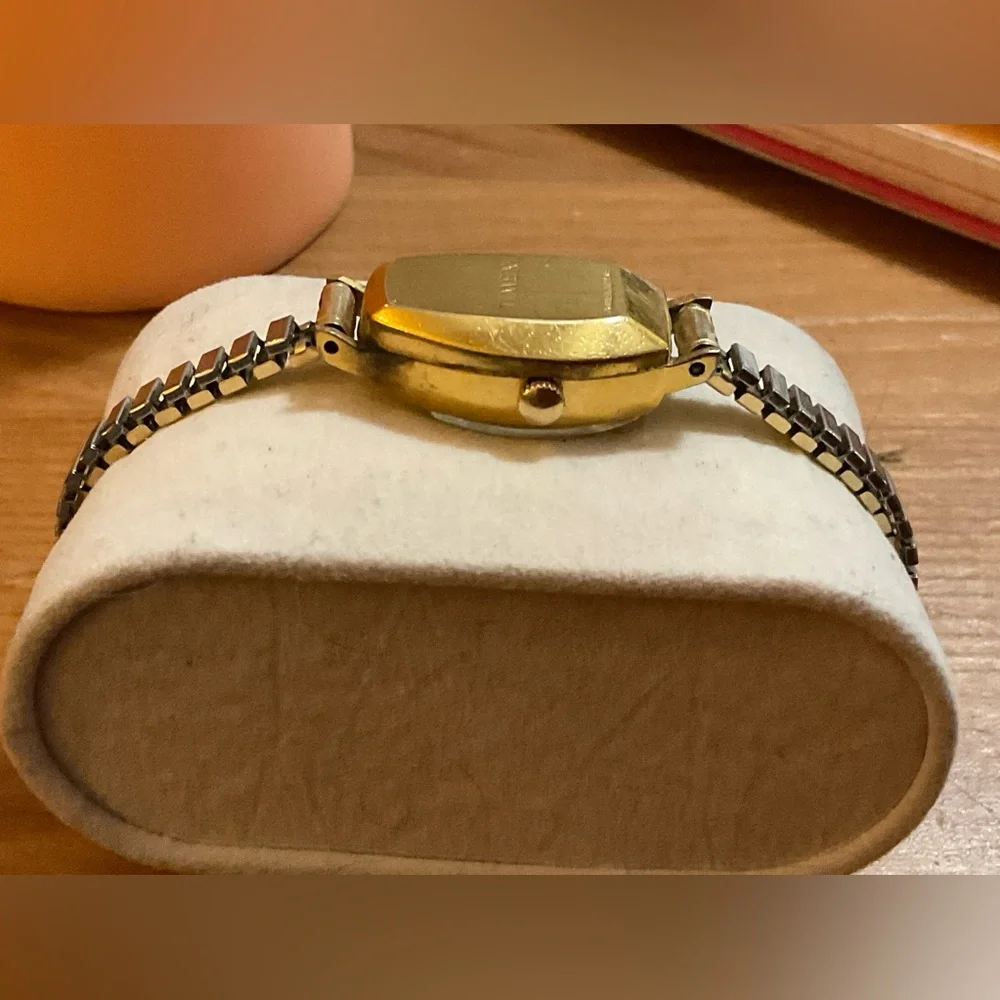 Timex: Woman’s vintage (70S) gold filled electric wrist watch with thin band.