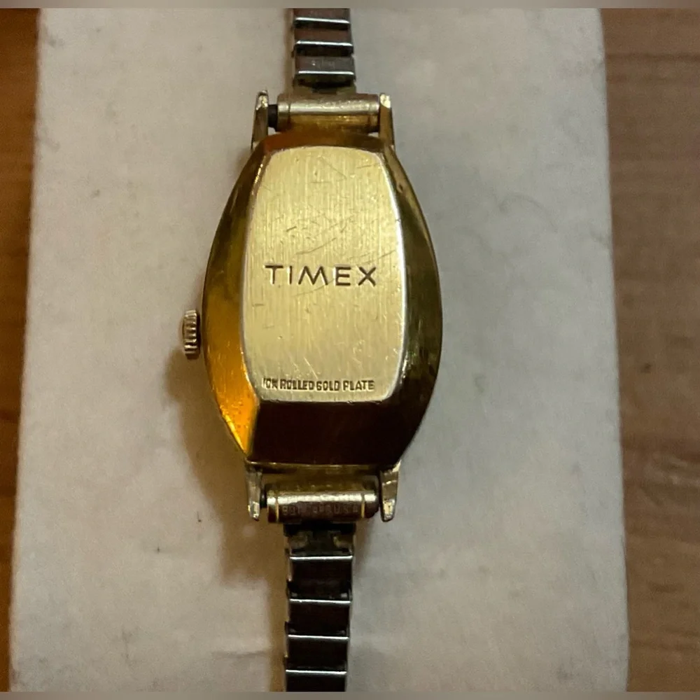 Timex: Woman’s vintage (70S) gold filled electric wrist watch with thin band.