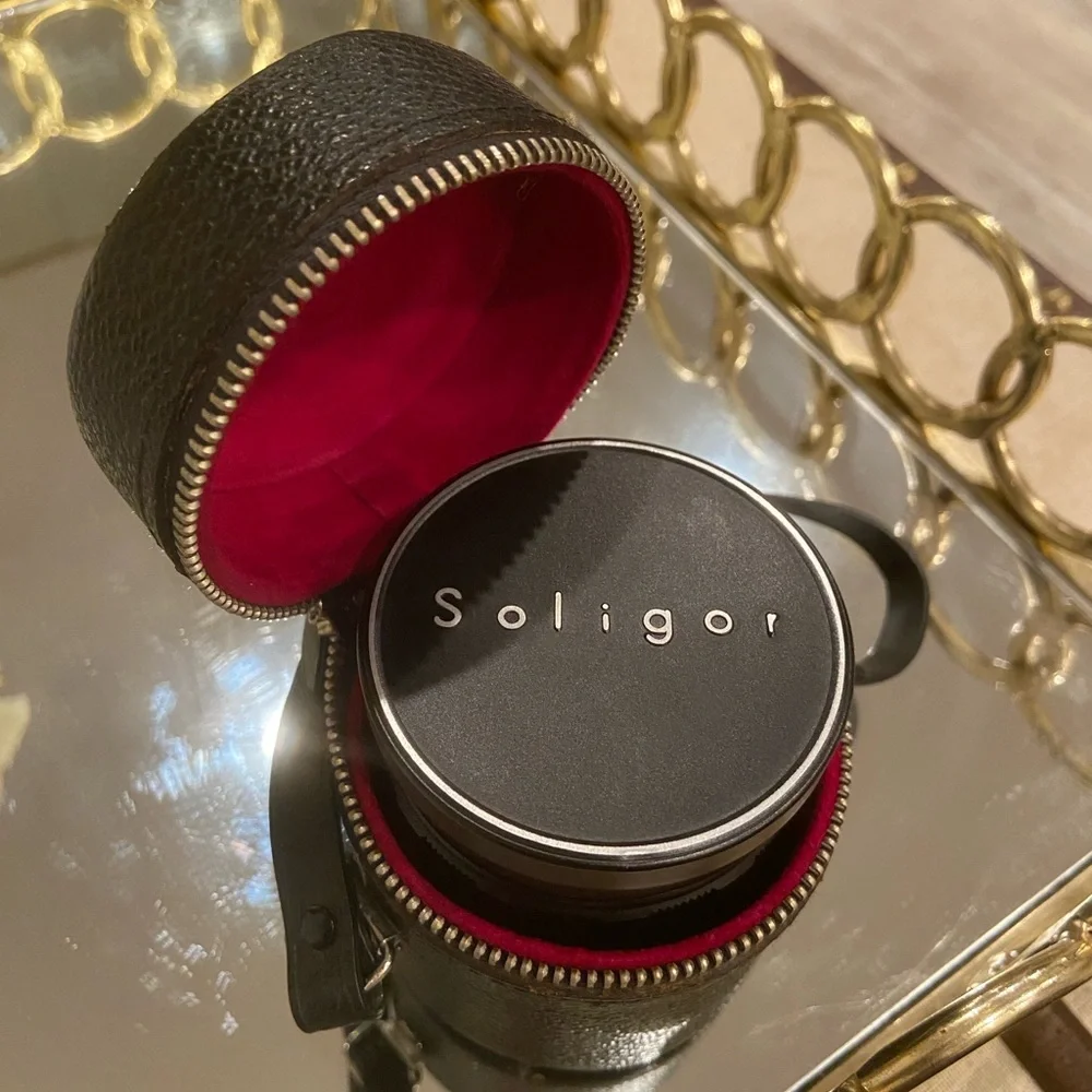 Soligor lens with black leather case included