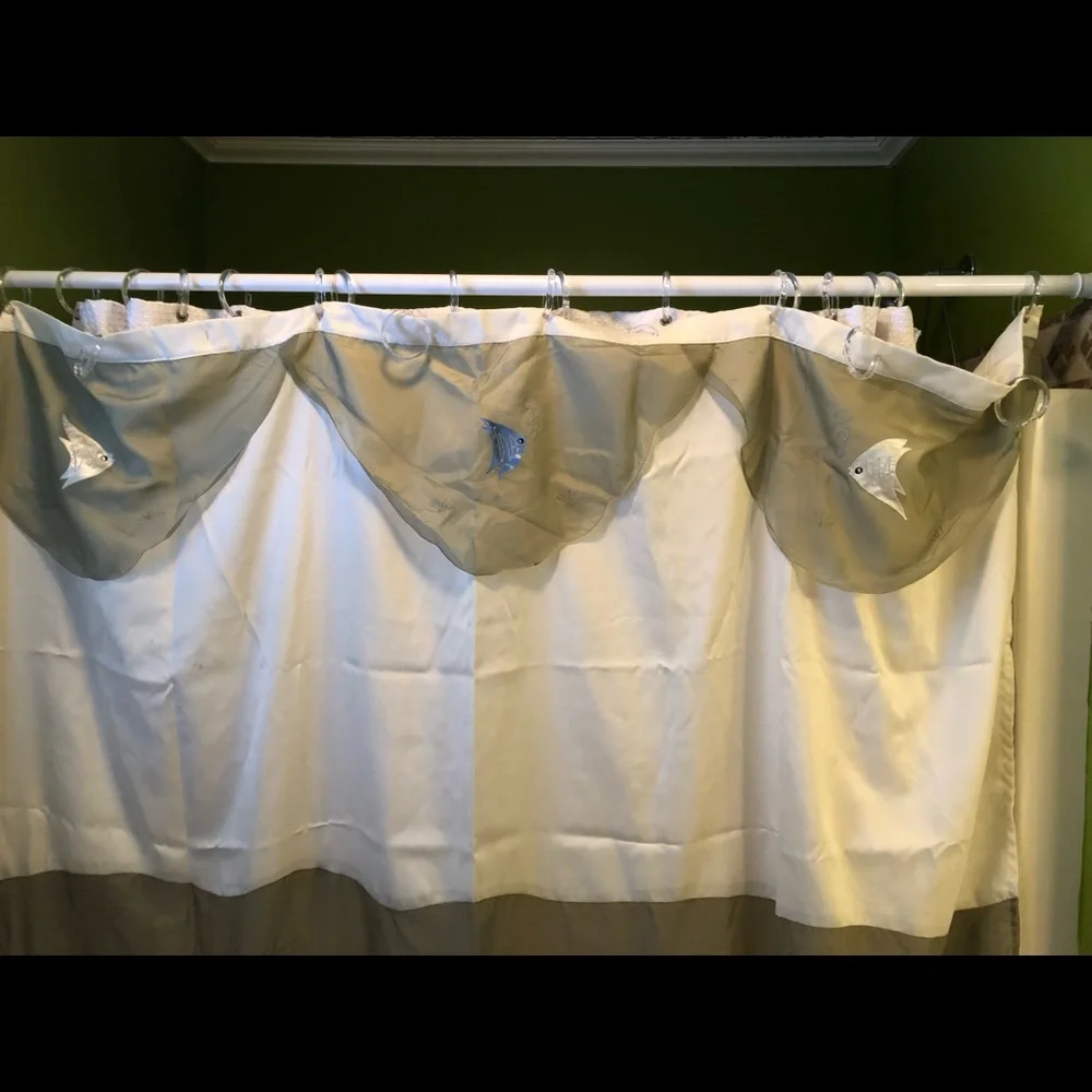 Green and cream fabric shower curtain with embroidered fish