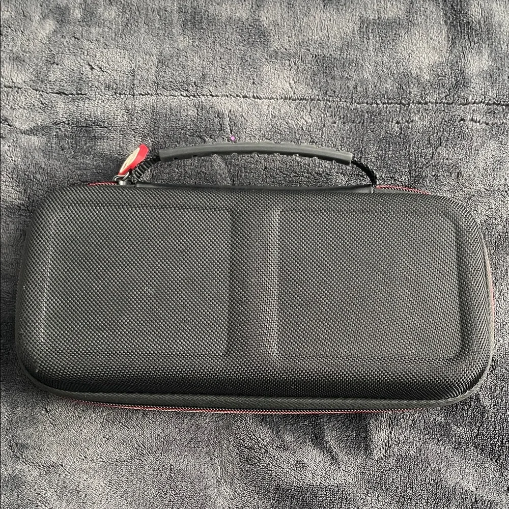 Nintendo Switch Black case with red and light grey accent stitching.