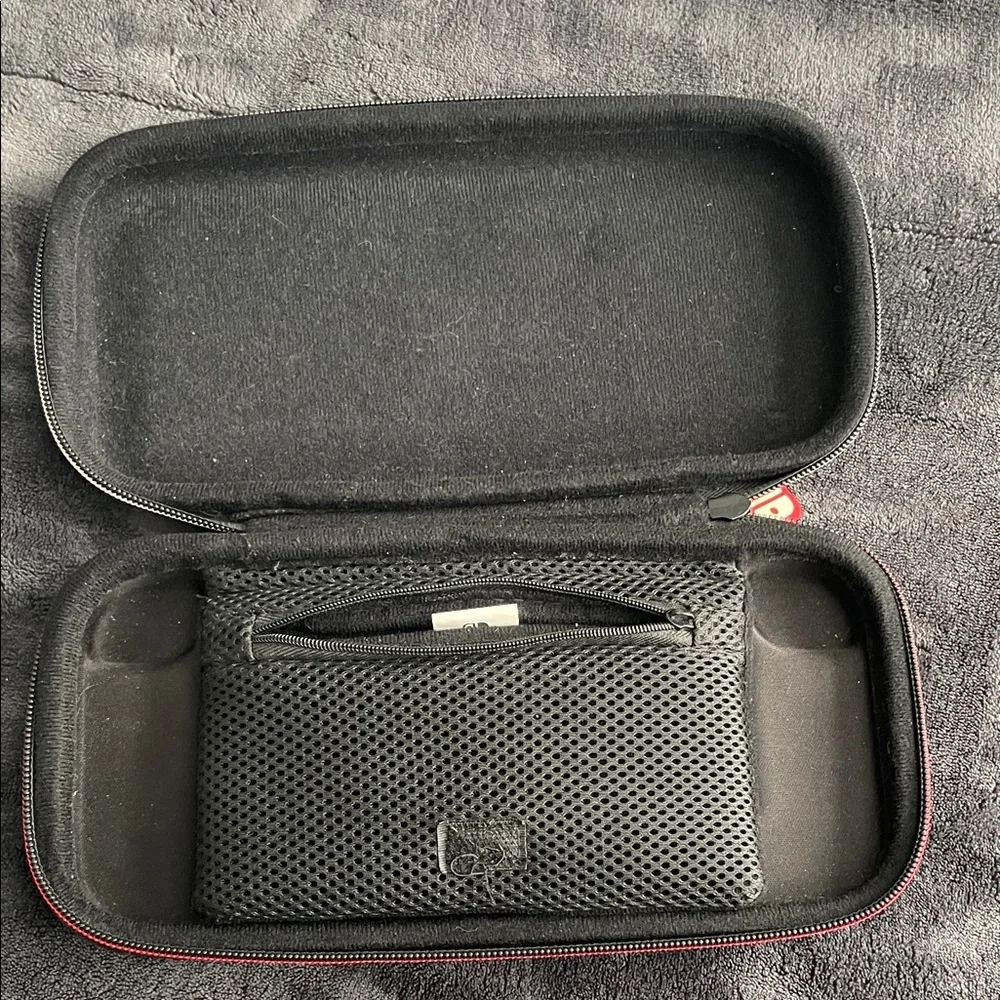 Nintendo Switch Black case with red and light grey accent stitching.