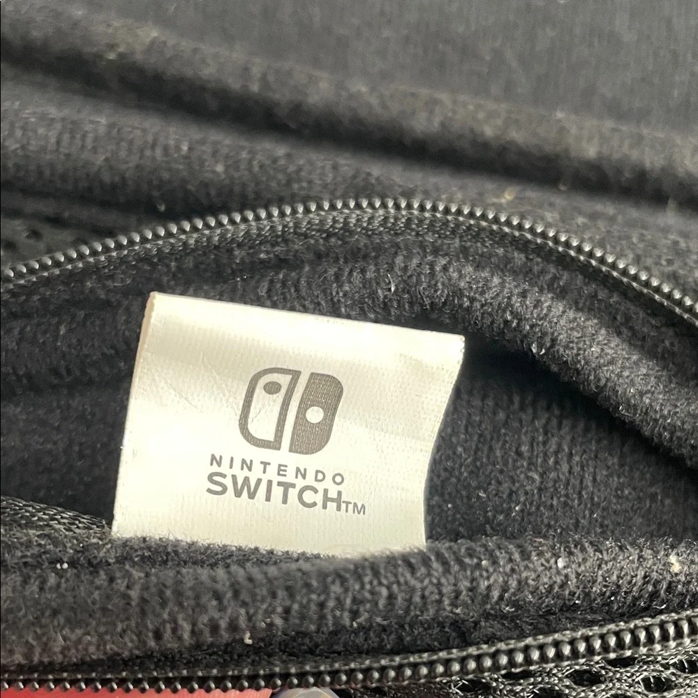 Nintendo Switch Black case with red and light grey accent stitching.