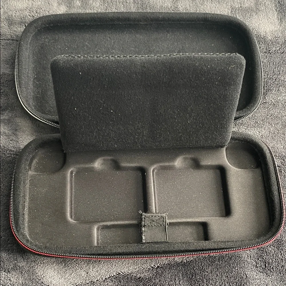 Nintendo Switch Black case with red and light grey accent stitching.