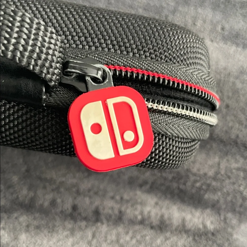 Nintendo Switch Black case with red and light grey accent stitching.