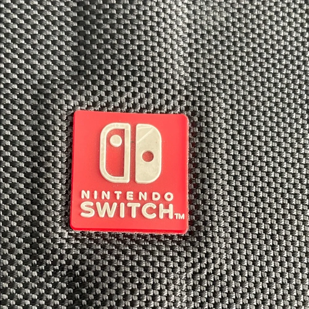 Nintendo Switch Black case with red and light grey accent stitching.