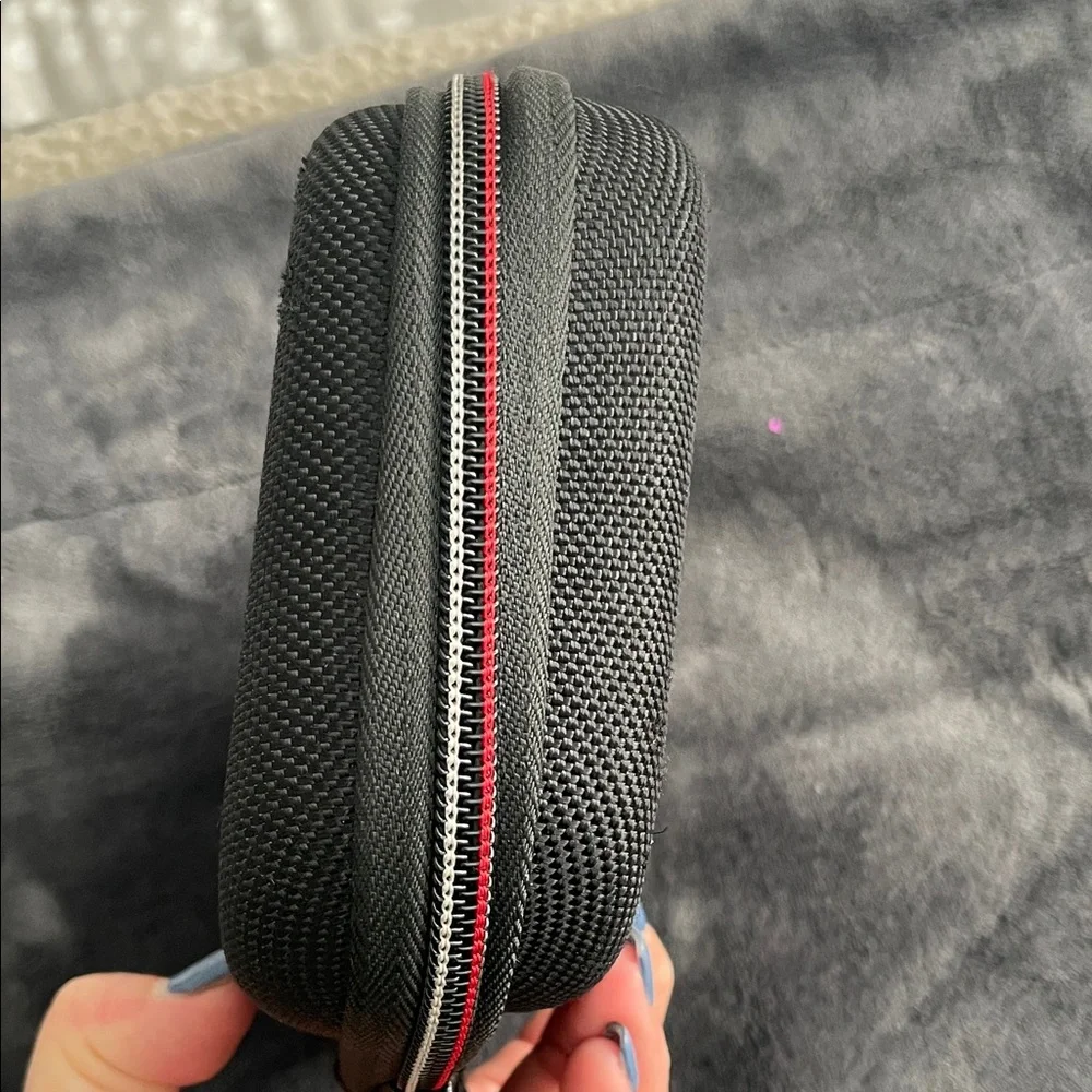 Nintendo Switch Black case with red and light grey accent stitching.