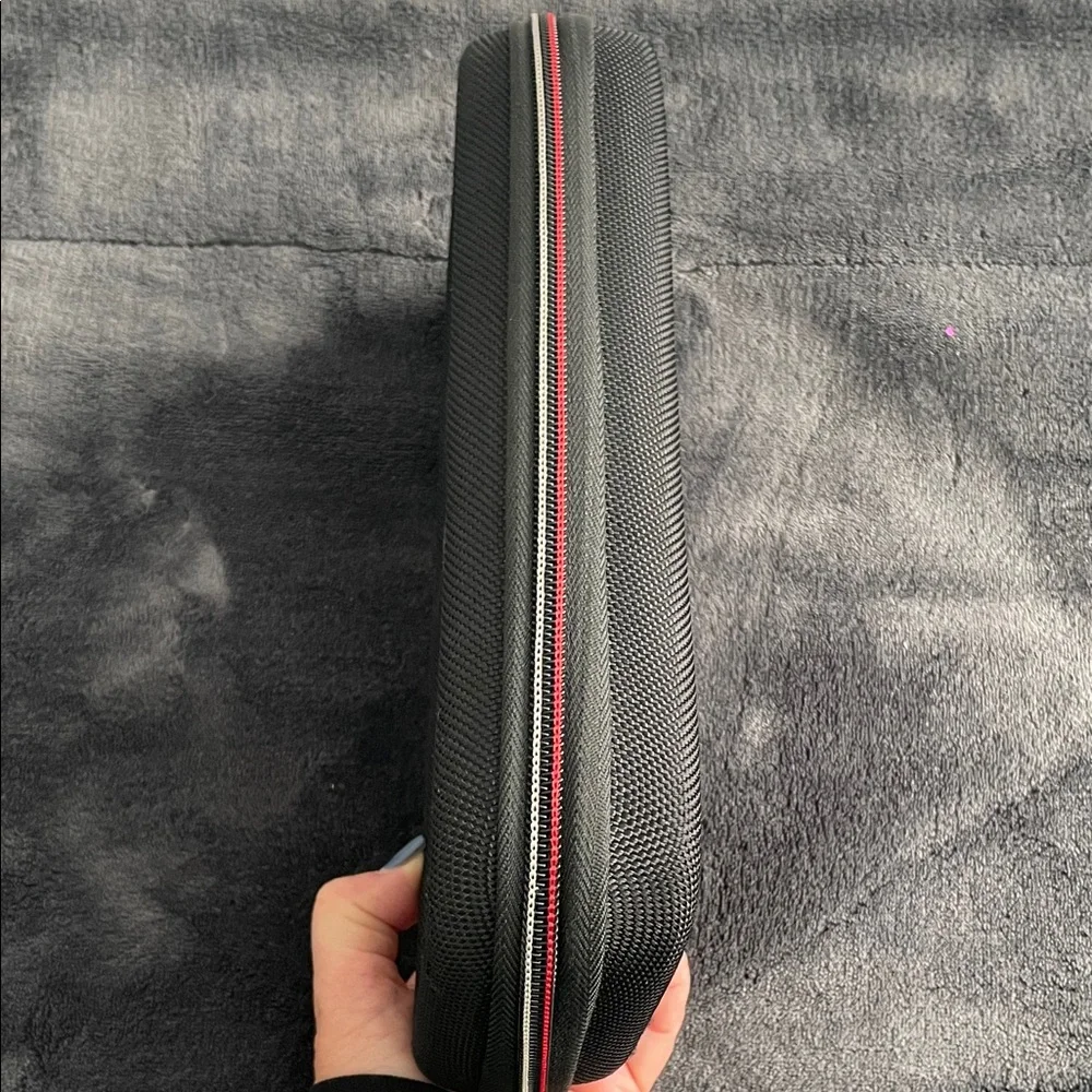 Nintendo Switch Black case with red and light grey accent stitching.