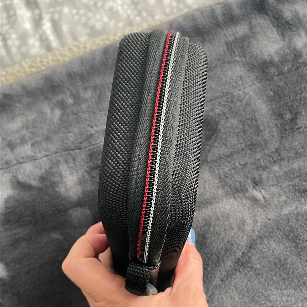 Nintendo Switch Black case with red and light grey accent stitching.