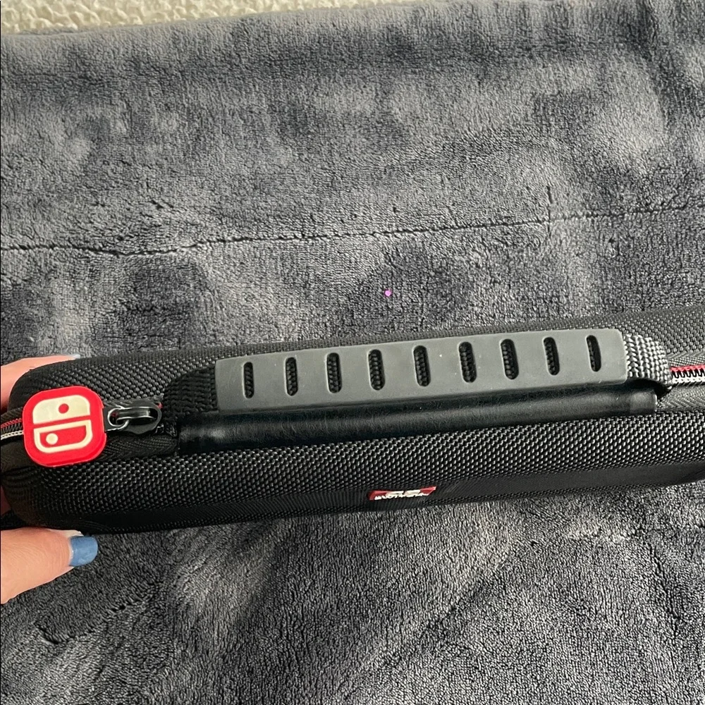Nintendo Switch Black case with red and light grey accent stitching.