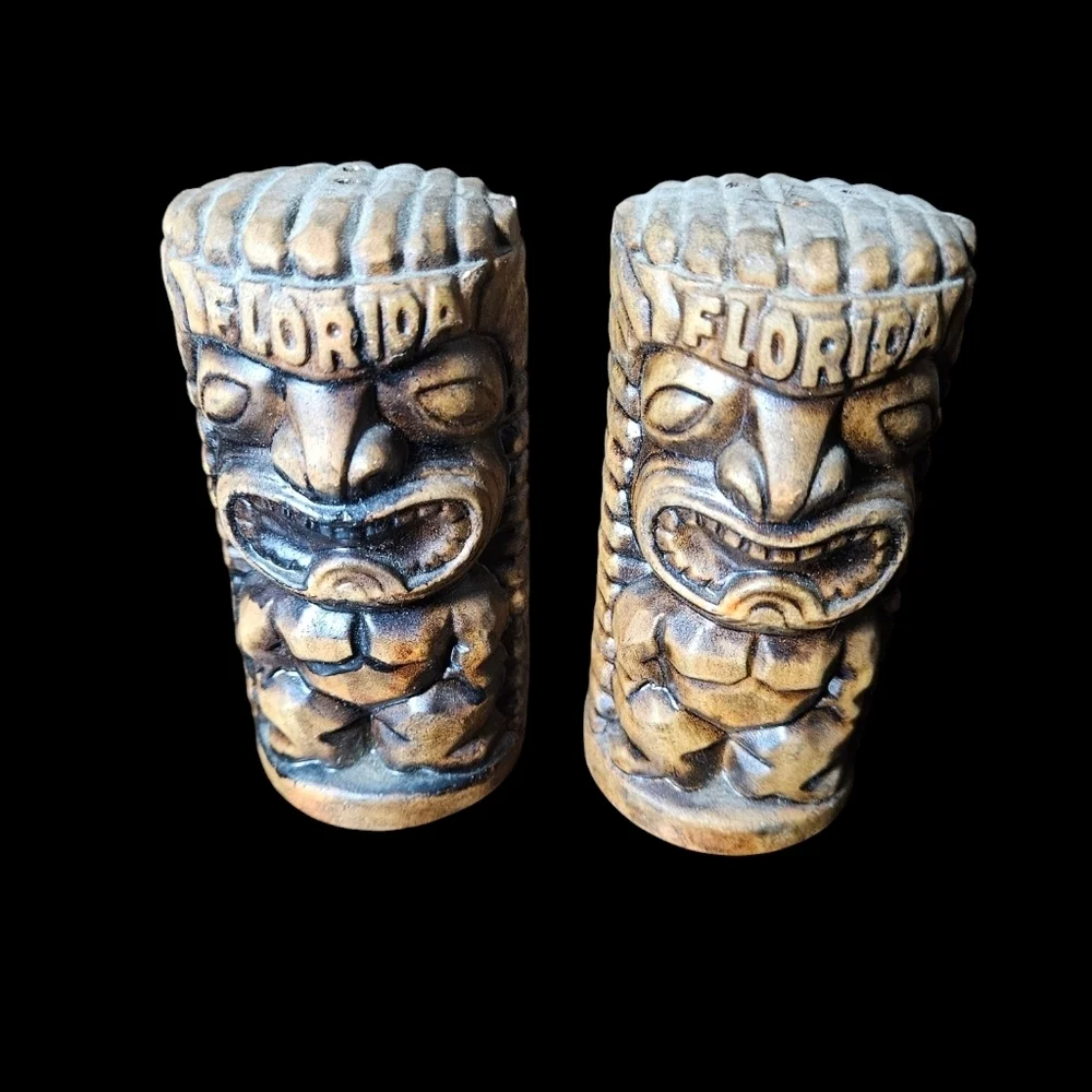 Set of vintage Florida ceramic tiki salt and pepper shakers.