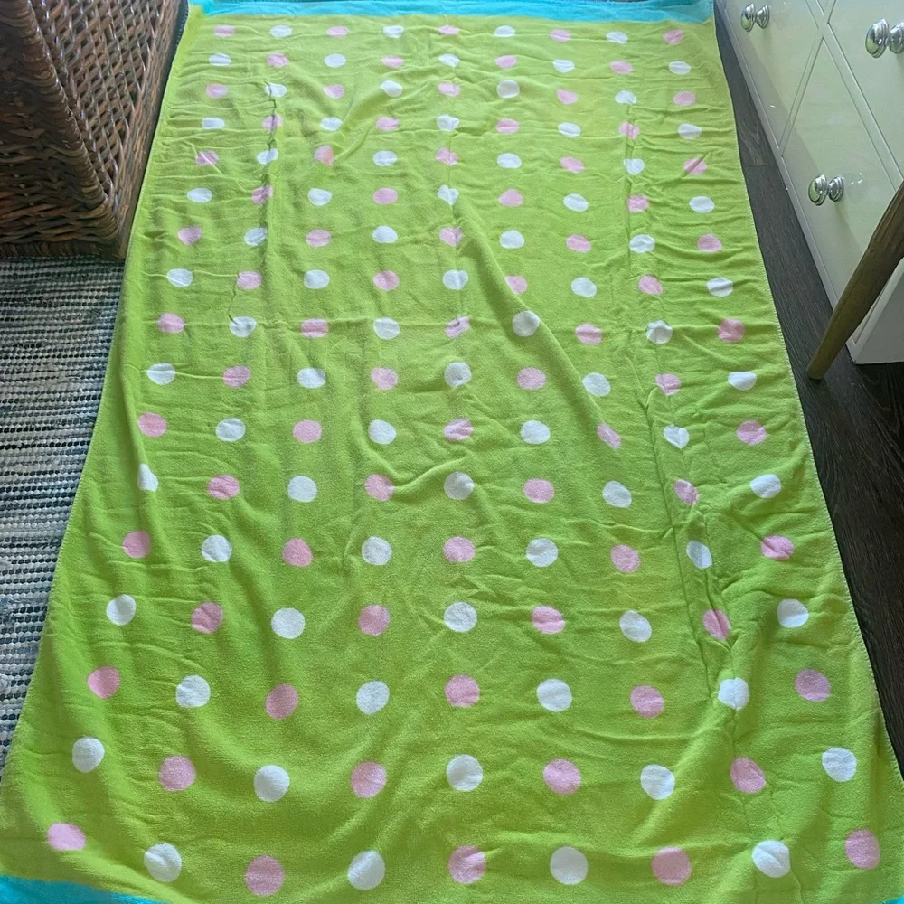 Green, pink, white, and blue beach towel