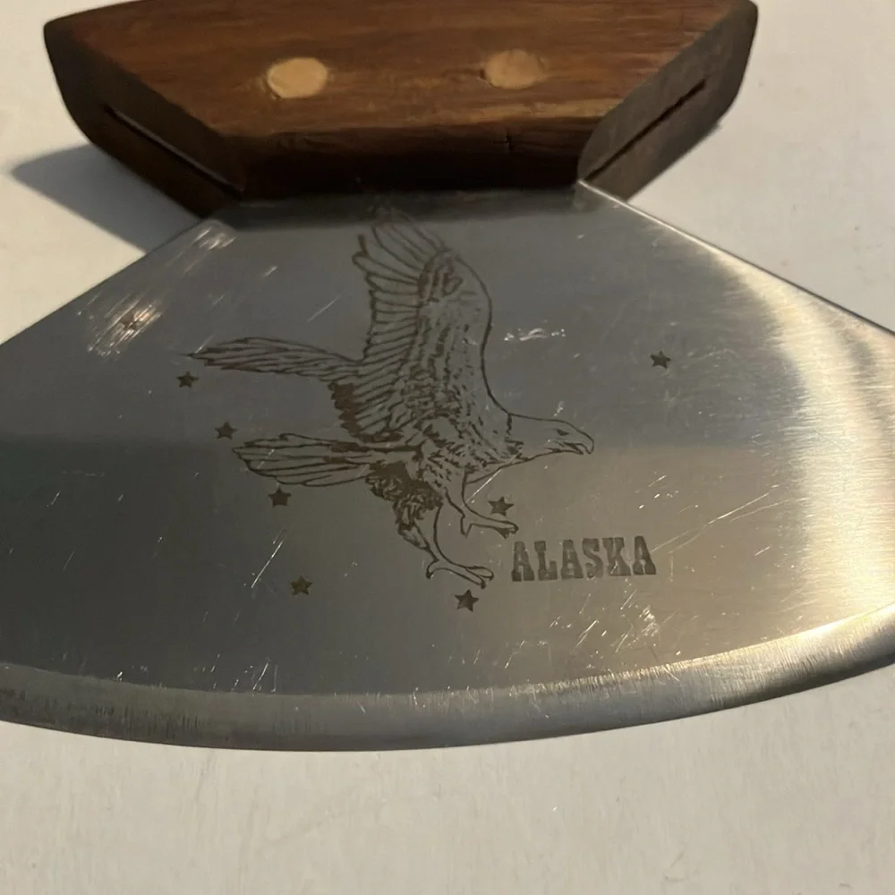 Alaskan Ulu knife with a walnut wood handle and‎ a stand.