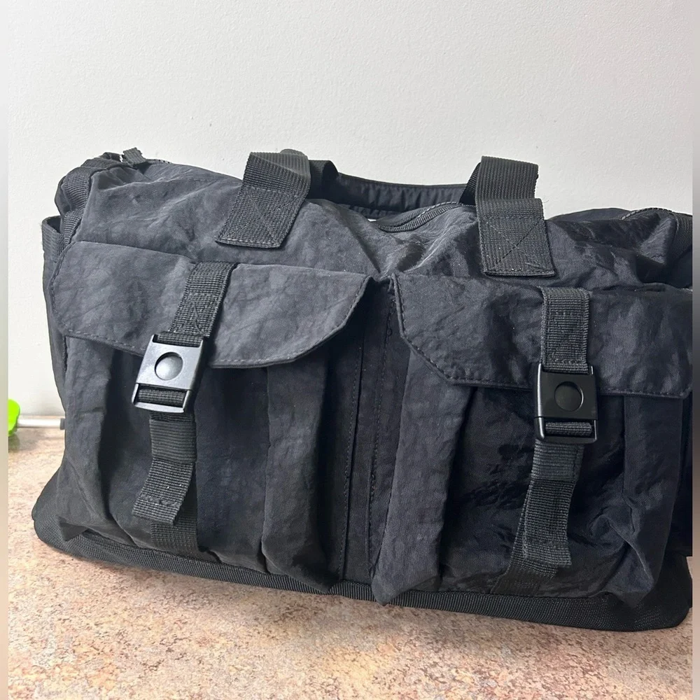 Tommy Bahama black travel duffle bag with hand and shoulder straps