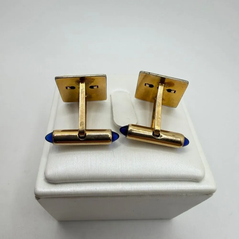 Vintage Krementz Gold tone cuff likes with princess cut blue rhinestone accents!