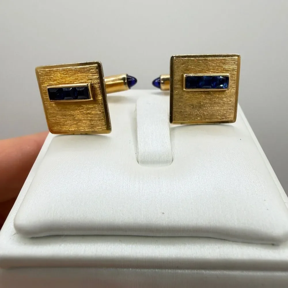 Vintage Krementz Gold tone cuff likes with princess cut blue rhinestone accents!