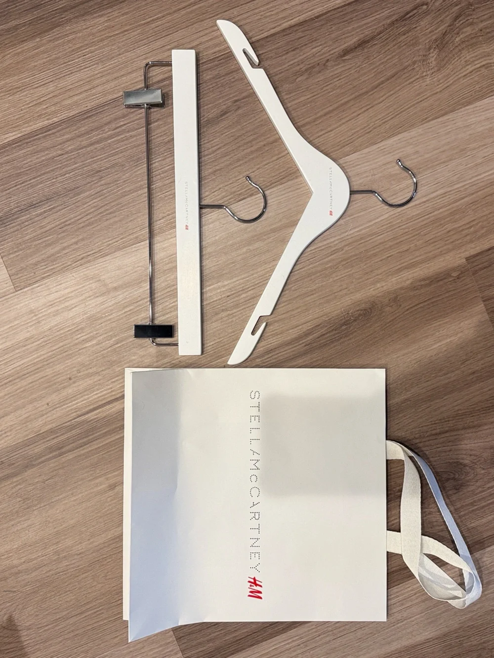Stella McCartney H&M White Branded Shopping Bag with White Wooden Hangers