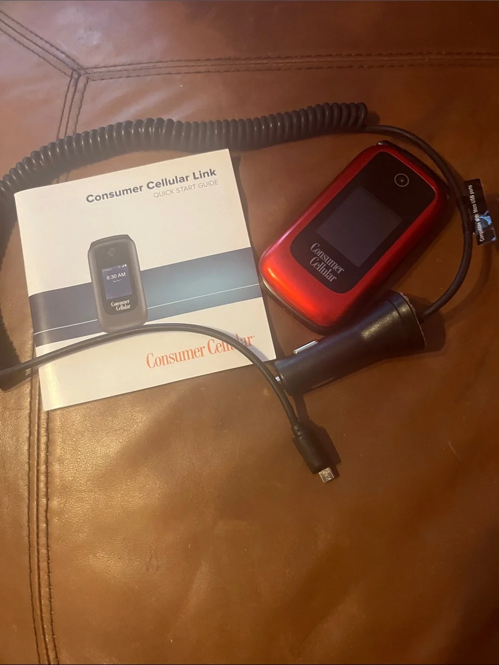 Consumer Cellular Red Flip Phone with car Charger.