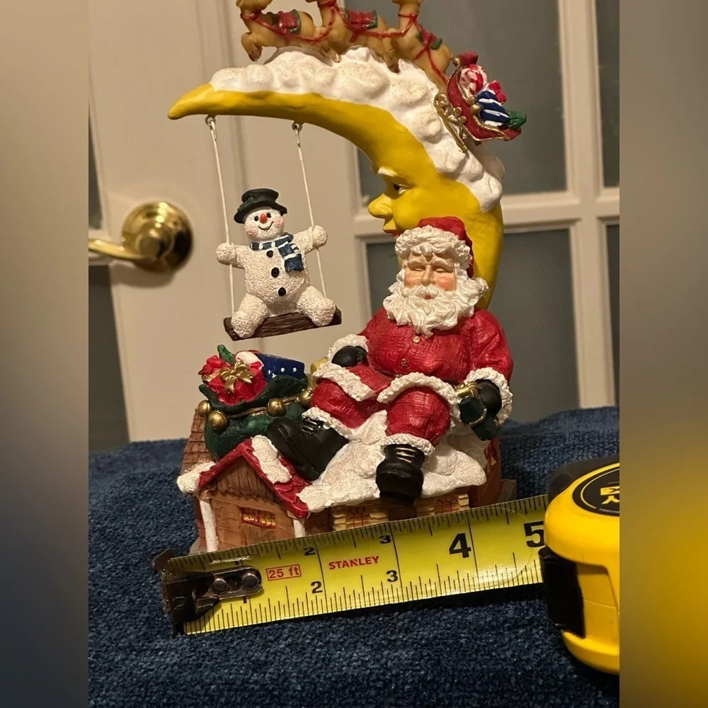 Sleepy Santa rests while a snow buddy swings. Missing bottom