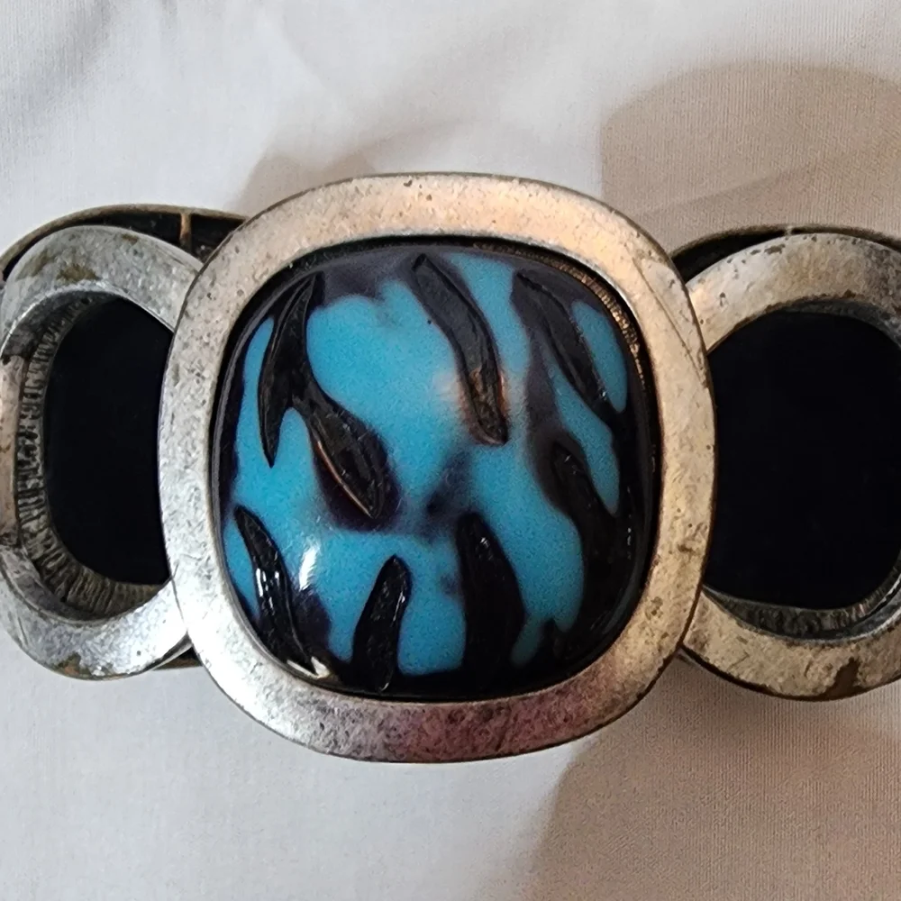 Cuff bracelet with a large, square, blue and black stone set in a Silver Tone