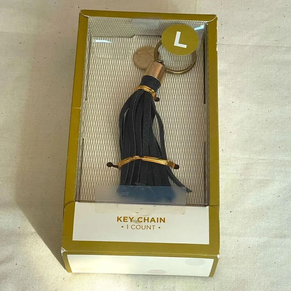 Black leather fringe keychain with gold coin “L” letter initial (NWT)