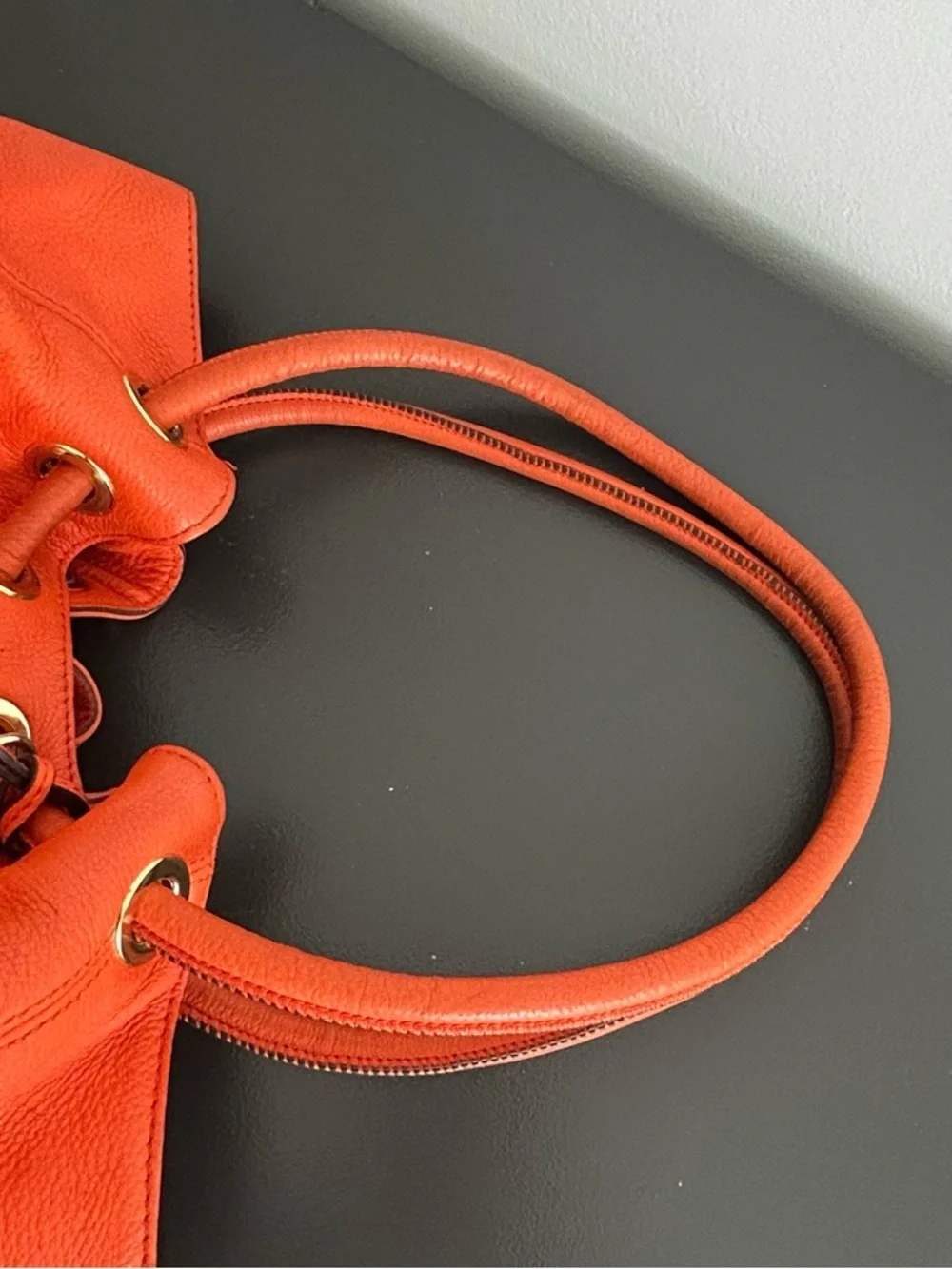 Michael Kors Orange Pebbled Leather Drawstring Tote tassel shoulder bag