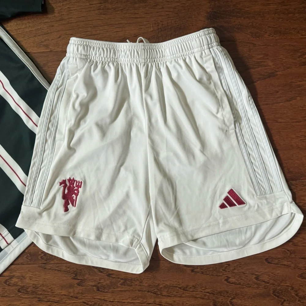 White Adidas Soccer Shorts with Red Manchester United Logo, size Medium 11-12Y