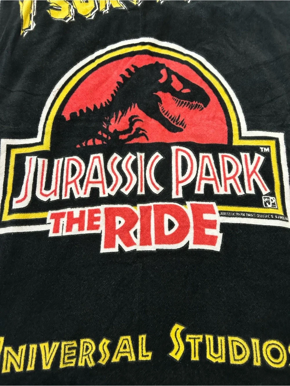 vintage 1990s Jurassic Park The Ride beach towel featuring the iconic movie logo