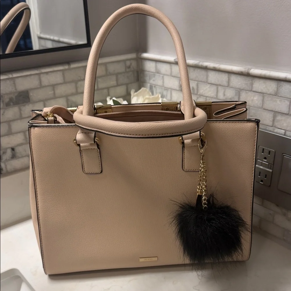 Elegant Cream Handbag with Black Charm