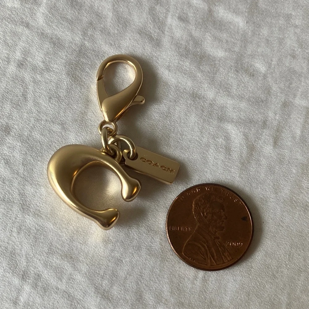 Coach: Metallic Gold Tone Key Holder Charm