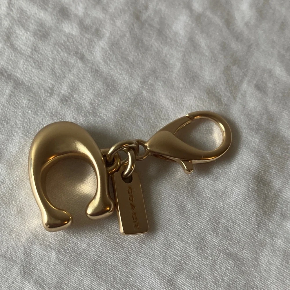Coach: Metallic Gold Tone Key Holder Charm