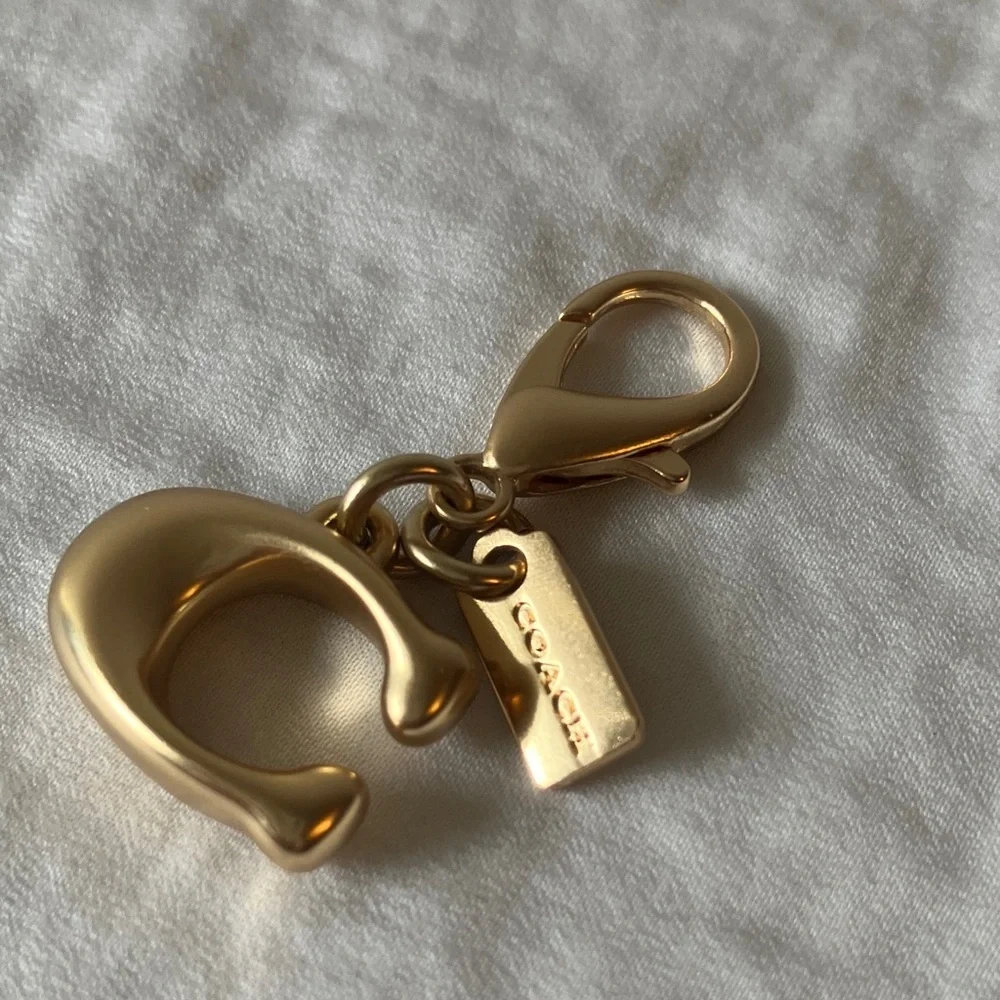 Coach: Metallic Gold Tone Key Holder Charm
