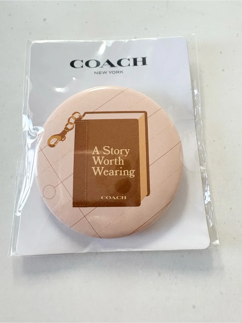 Coach round brooch