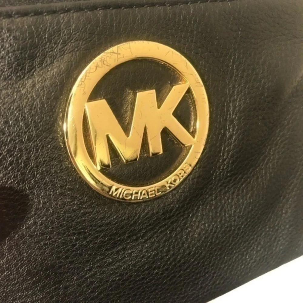 Michael Kors scratches logo