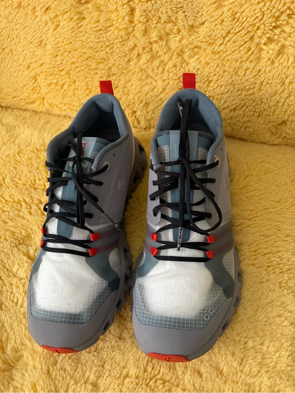 On Running Gray and Red Trail Runners