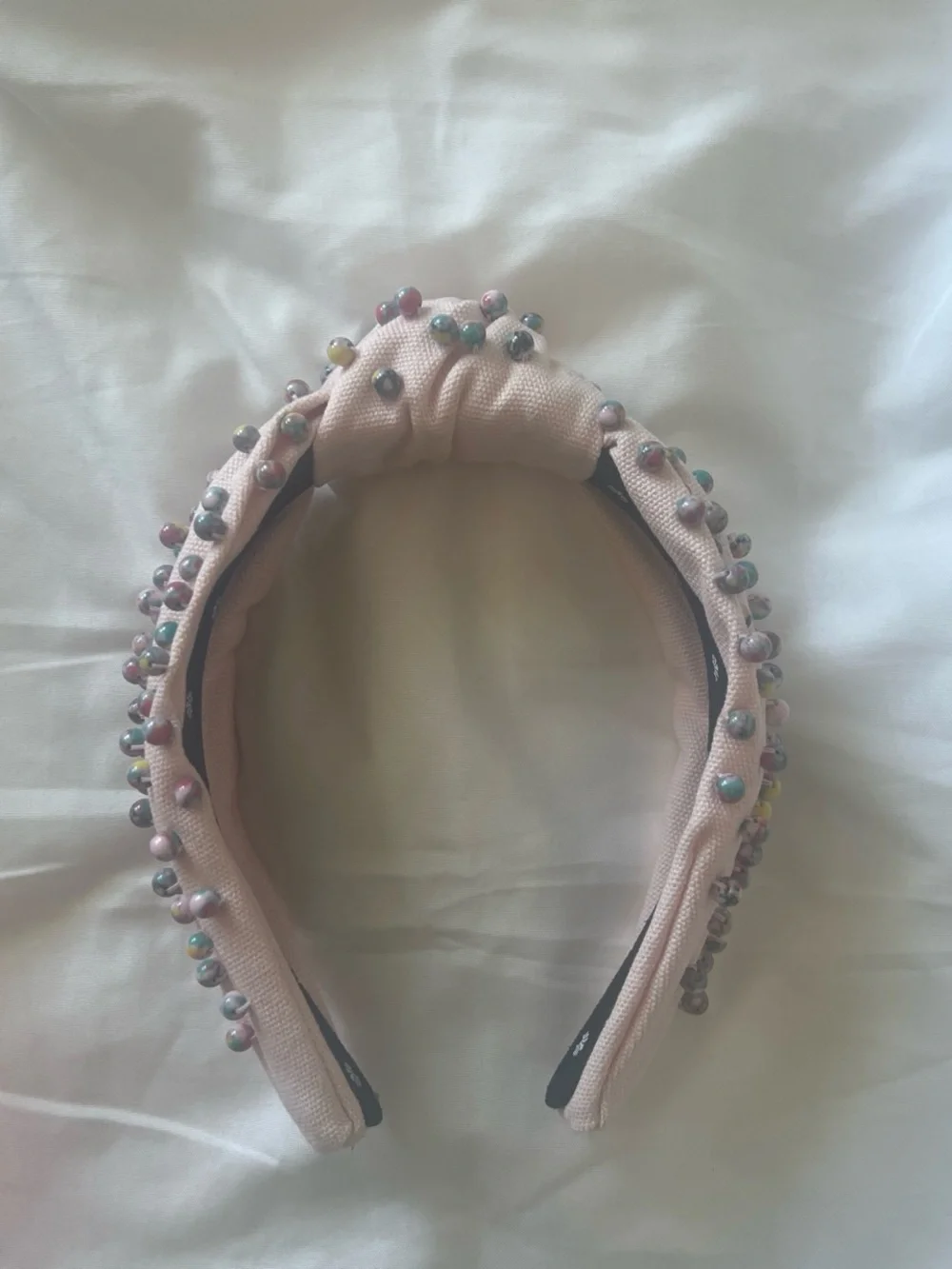 Lele Sadoughi pale pink headband with silver motifs