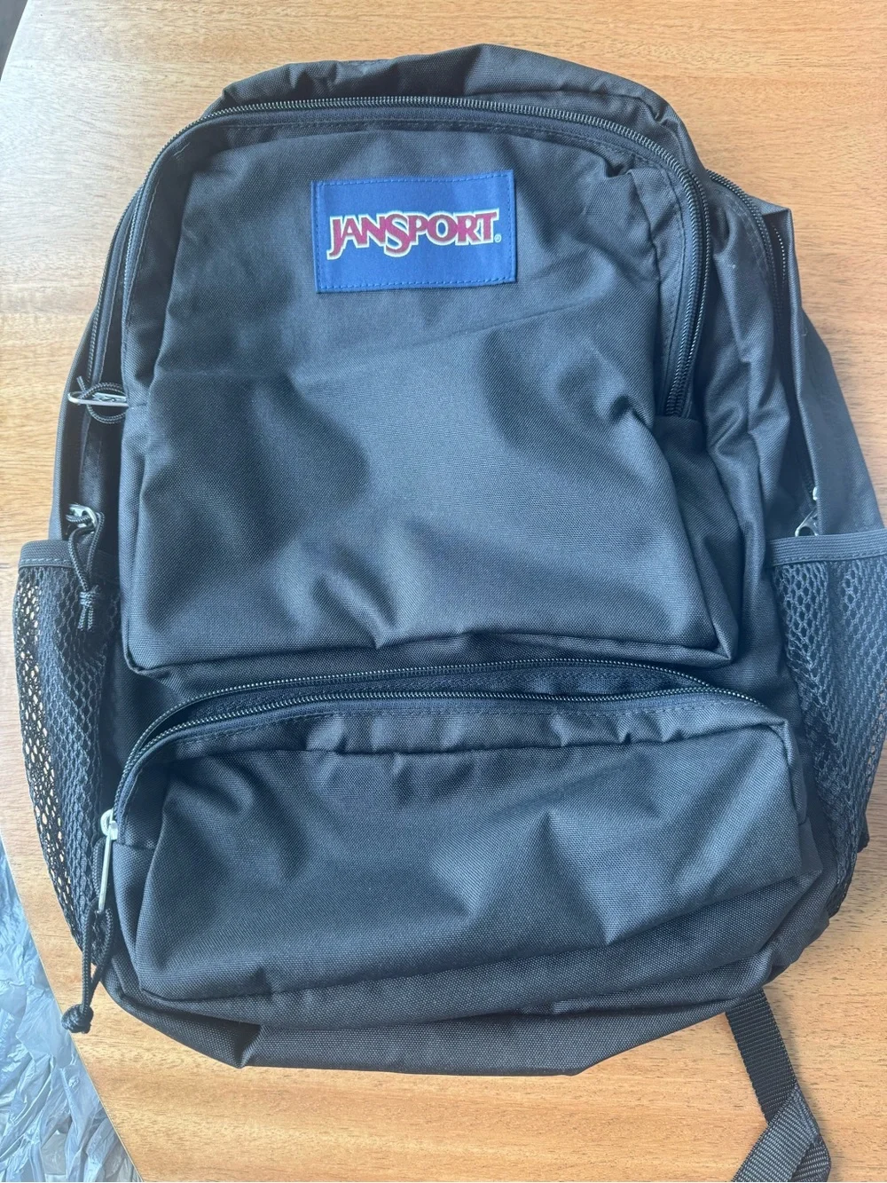 Jansport Black Backpack with Blue Logo Patch