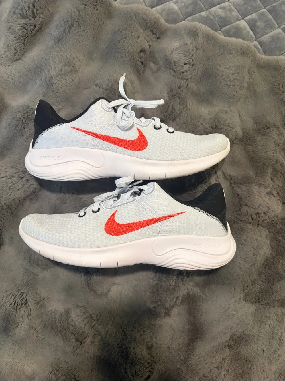 Nike Kids White Sneakers with Red Swoosh and Black Heel