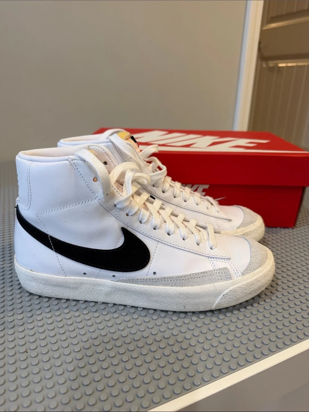 Nike White High-Top Sneakers with Black Swoosh