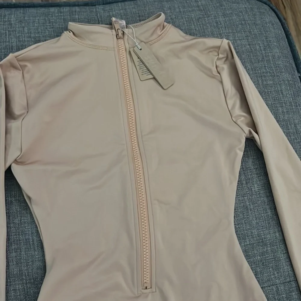 SKIMS swim zip