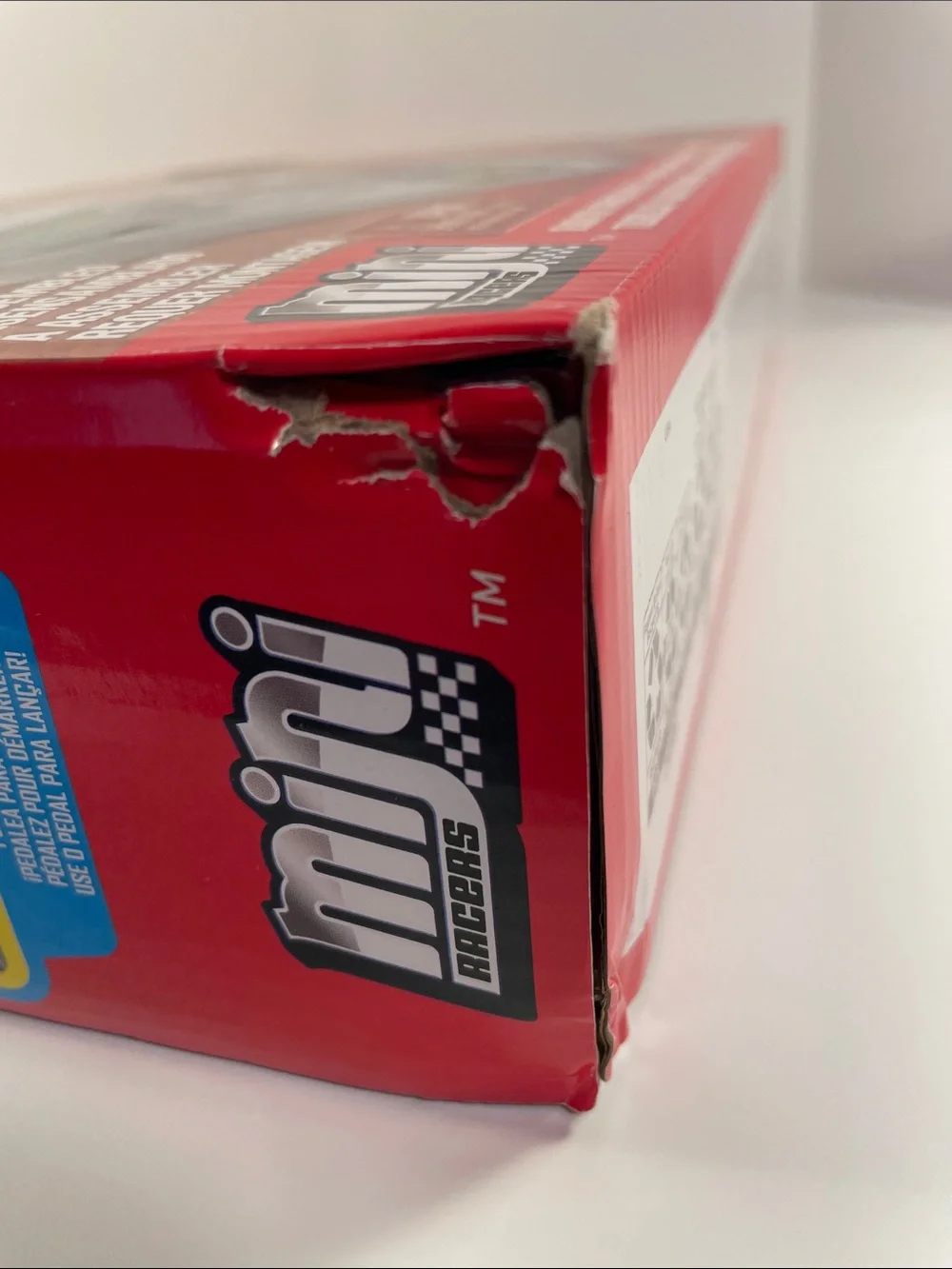 Mini Racers-Cardboard Packaging has dents and a torn spot as shown