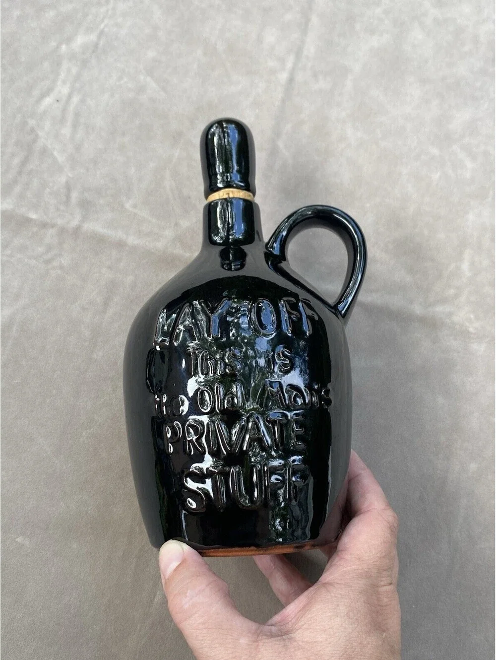 Black Ceramic Jug, says “Lay Off.. This Is The Old Mans Private Stuff” with Cork