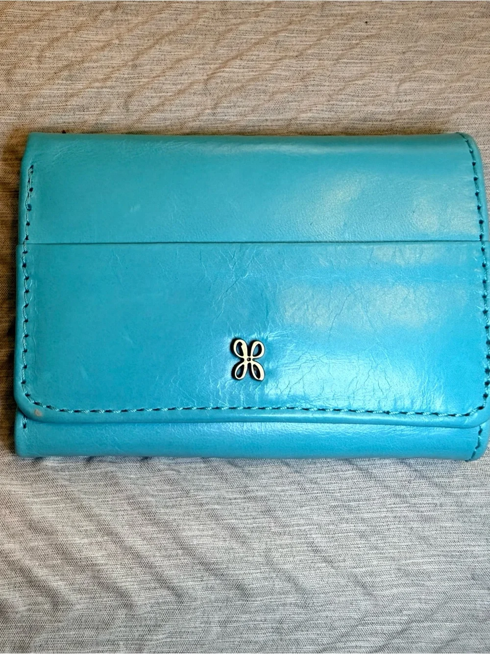 HOBO Turquoise Leather Wallet with Floral Metal Accent