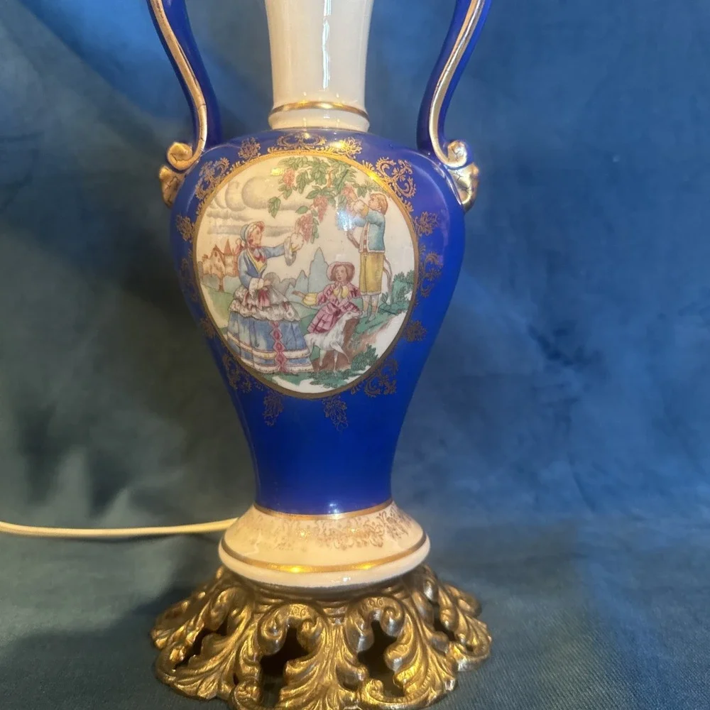 Antique porcelain urn lamp with grape-picking scene.