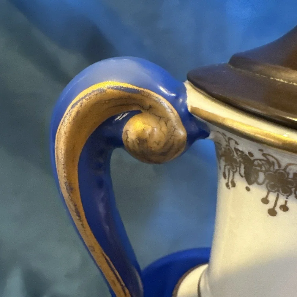 Antique porcelain urn lamp with grape-picking scene.