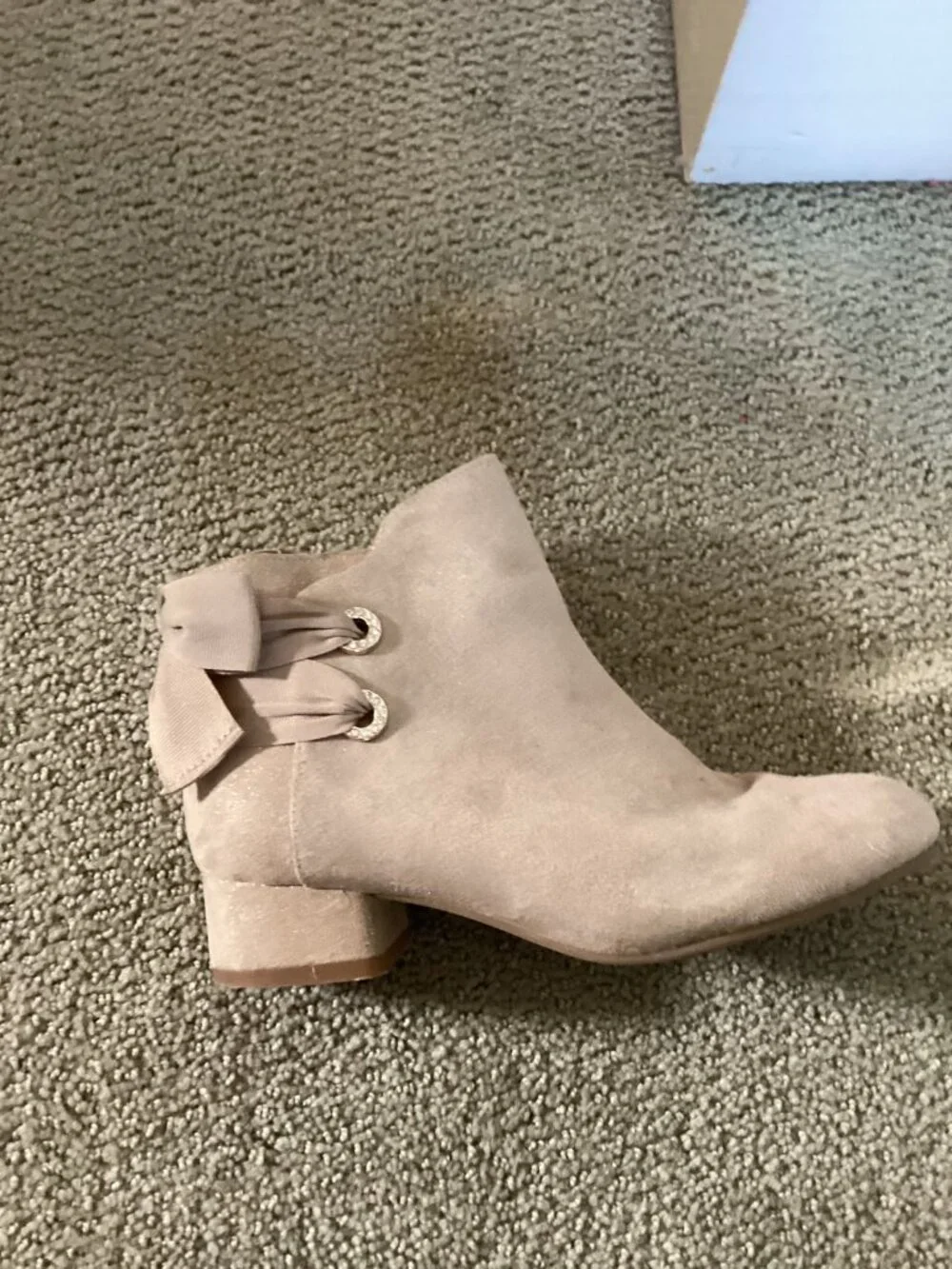 Heels for kids with bow on back of shoe.