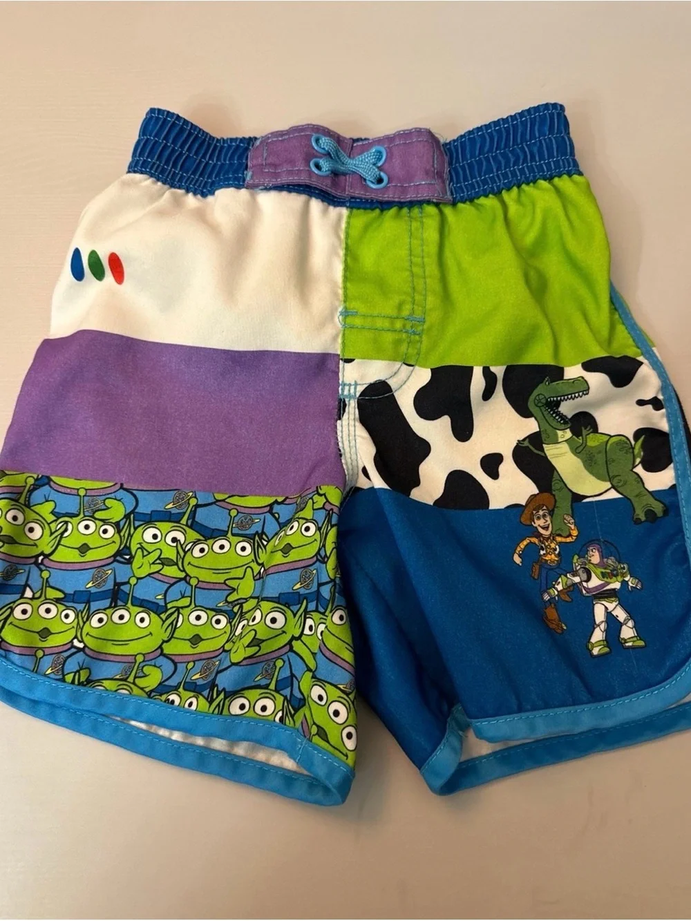 Disney Toy Story Patchwork Swim Shorts in Blue, Green & Purple