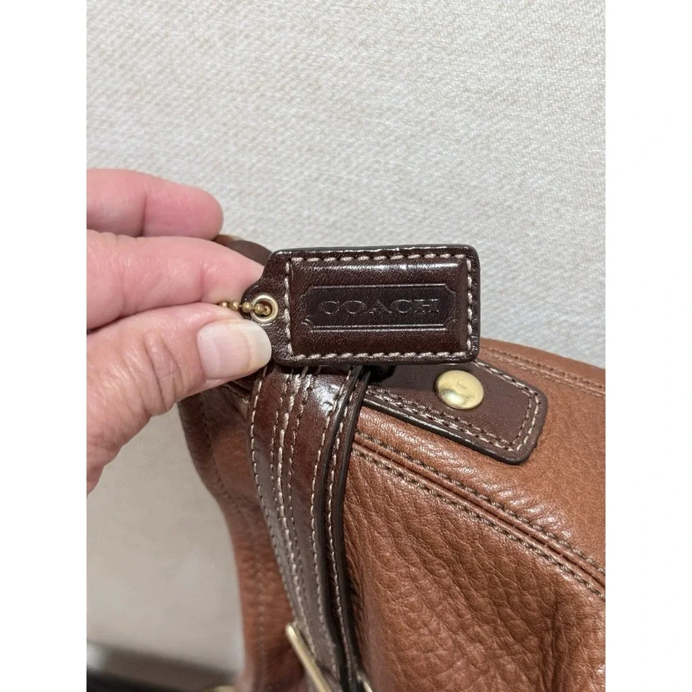 Coach features strap burnished